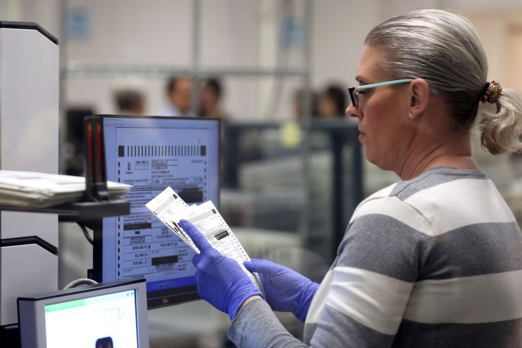 An election worker scans ballots at the Maricopa County Tabulation and Election Center on Nov. 11, 2022 in Phoenix, Arizona.