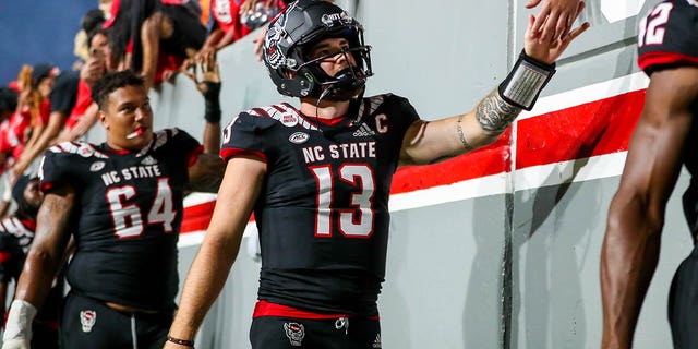 Devin Leary (13) of the North Carolina State Wolfpack celebrates with fans after a game against the Texas Tech Red Raiders Sept. 17, 2022, at Carter-Finley Stadium in Raleigh, N.C.