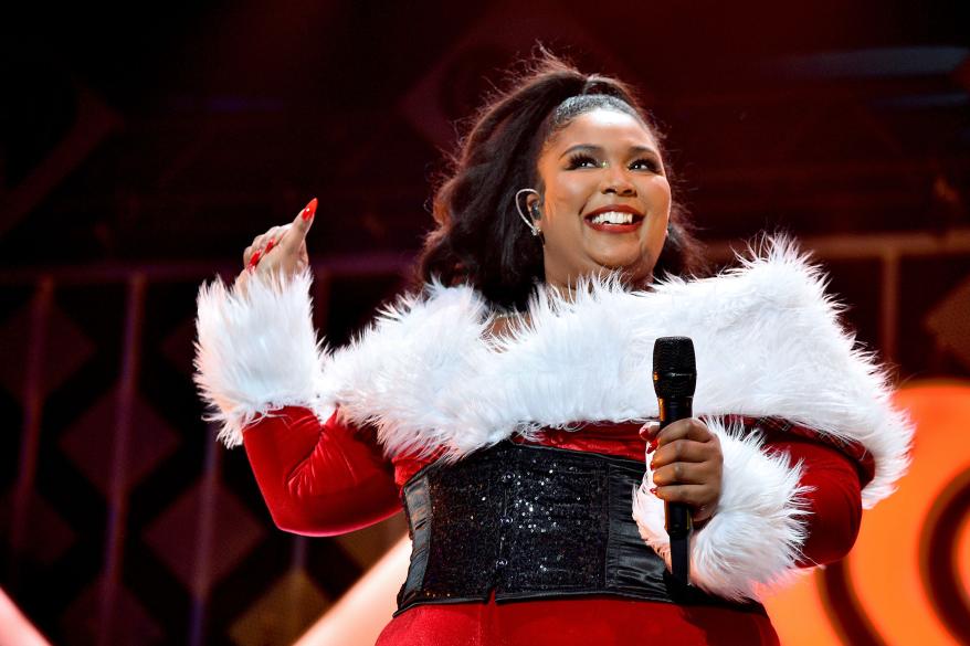 A picture of Lizzo performing at the iHeartRadio's Z100 Jingle Ball 2019.
