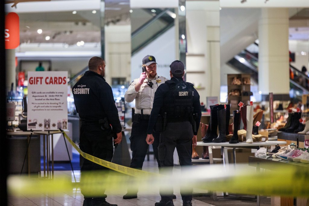 Security officers speak inside a store at the Mall of America in Bloomington, Minn.