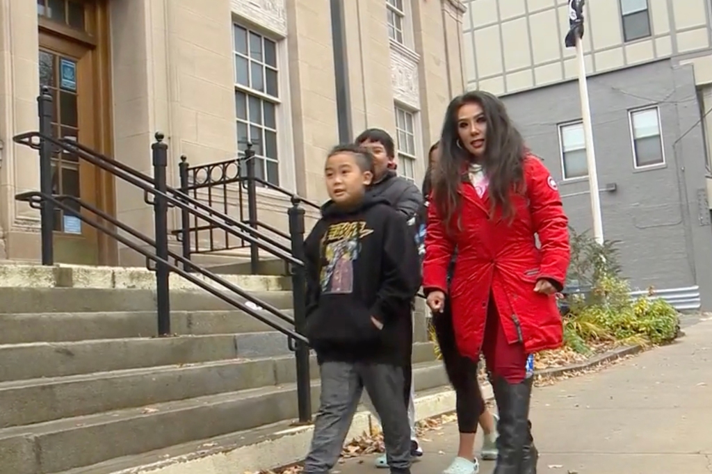 Desiree Thien and her three children outside of the Quincy post office.