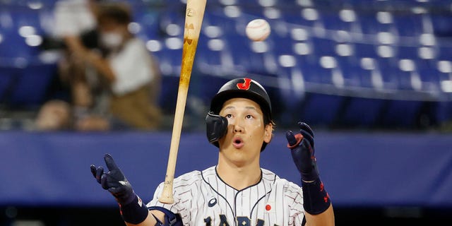 Outfielder Masataka Yoshida #34 of Team Japan reacts while at bat in the sixth inning against Team United States during the gold medal game between Team United States and Team Japan on day fifteen of the Tokyo 2020 Olympic Games at Yokohama Baseball Stadium on August 07, 2021 in Yokohama, Kanagawa, Japan.