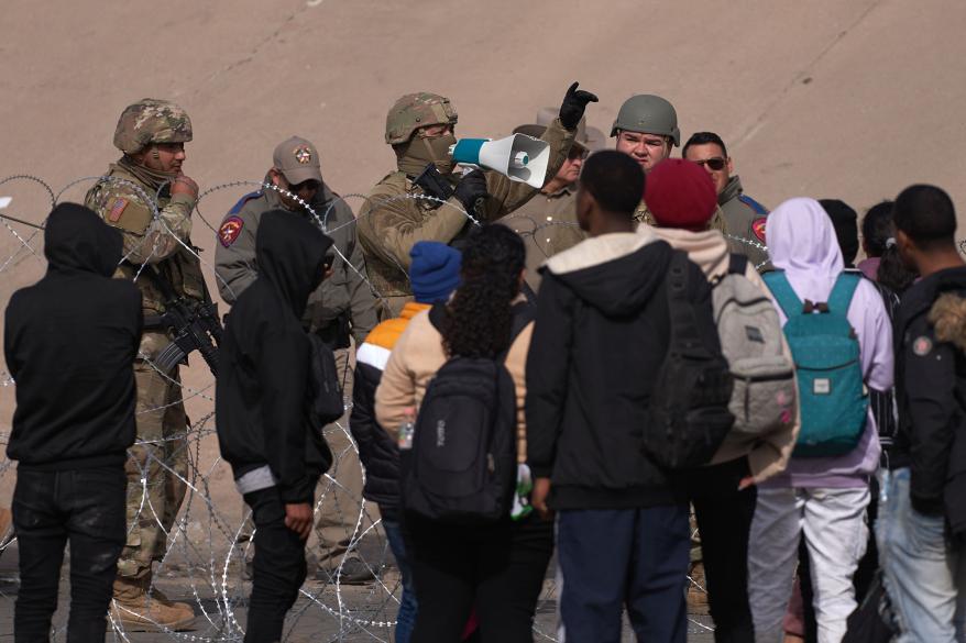 National Guards used loudspeakers to tell migrants in Spanish that it was illegal to cross.
