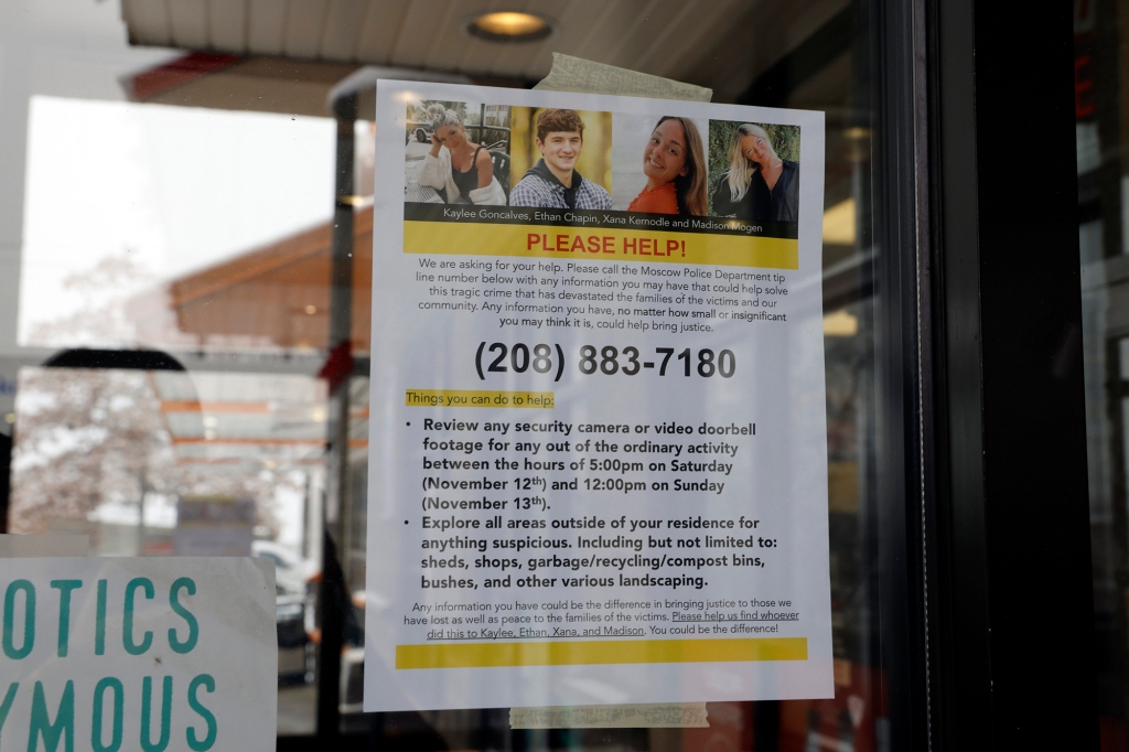 A flyer posted at a local business asking for help to find the person who killed the four students.