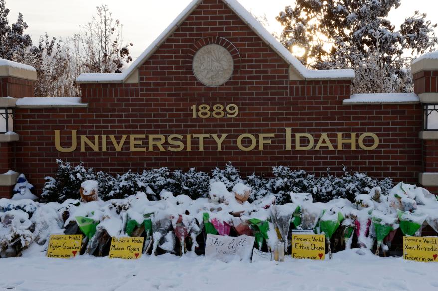 A Makeshift memorial was made in front of a brick wall at the University of Idaho.