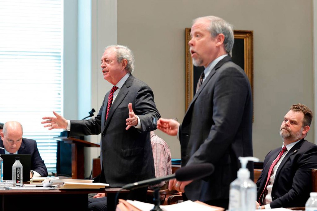 Defense attorney Dick Harpootlian, standing left, and prosecuting attorney Creighton Waters, standing right, discuss the release of evidence.