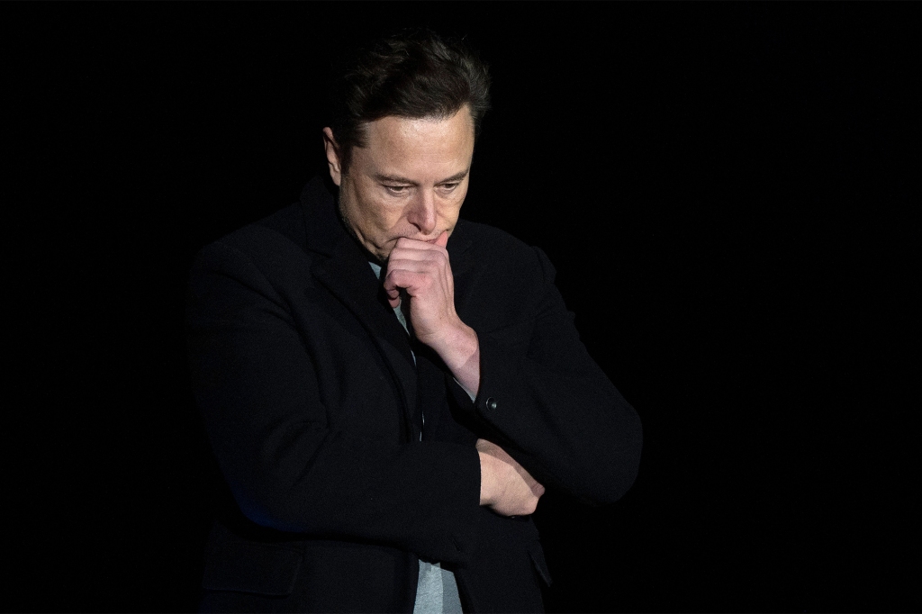Elon Musk pauses and looks down as he speaks during a press conference at SpaceX's Starbase facility near Boca Chica Village in South Texas on Feb. 10, 2022.