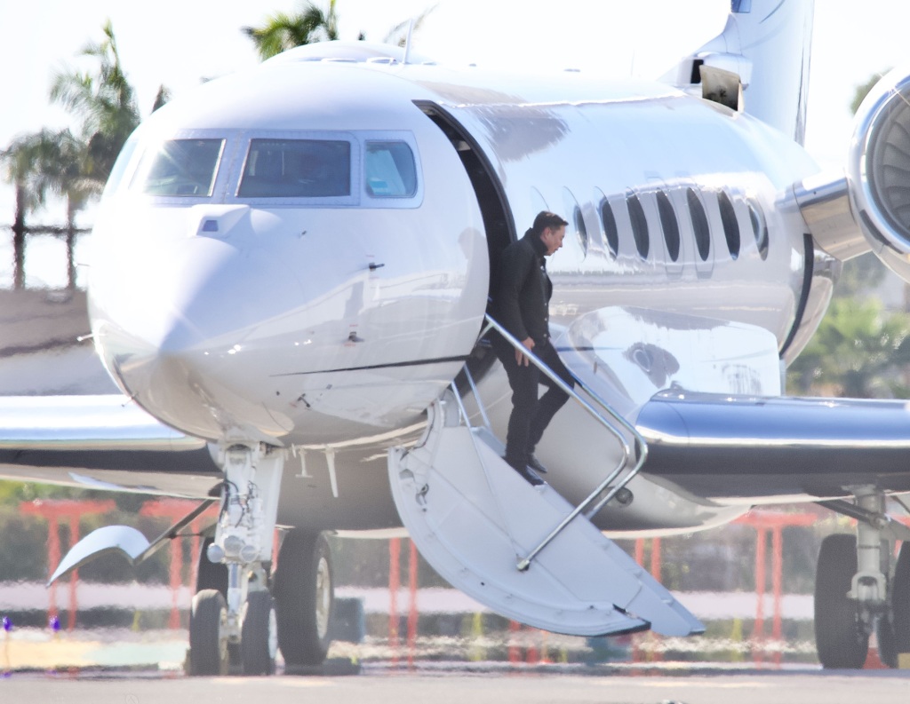 Musk exiting his private jet.