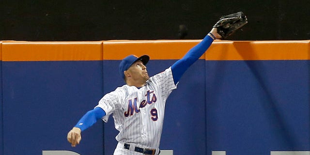 Brandon Nimmo #9 of the New York Mets makes a catch at the wall on a ball off the bat of Justin Turner of the Los Angeles Dodgers in the seventh inning at Citi Field on August 31, 2022 in New York City.