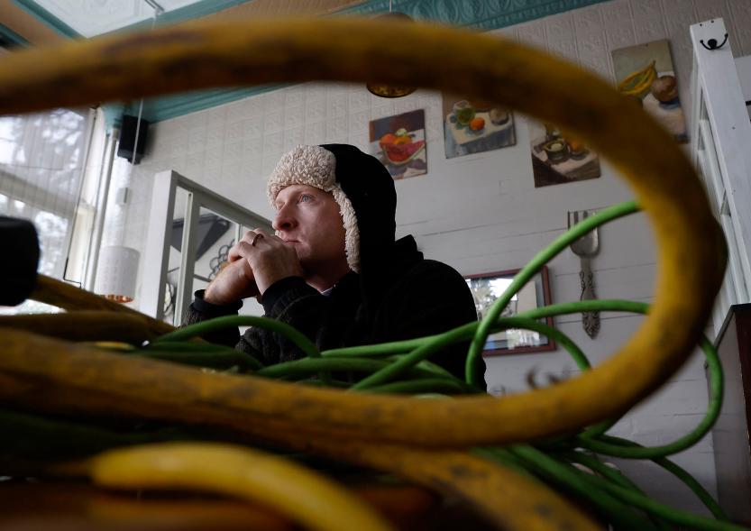 A picture of a Betsy's Crepes employee sitting next to power cords.