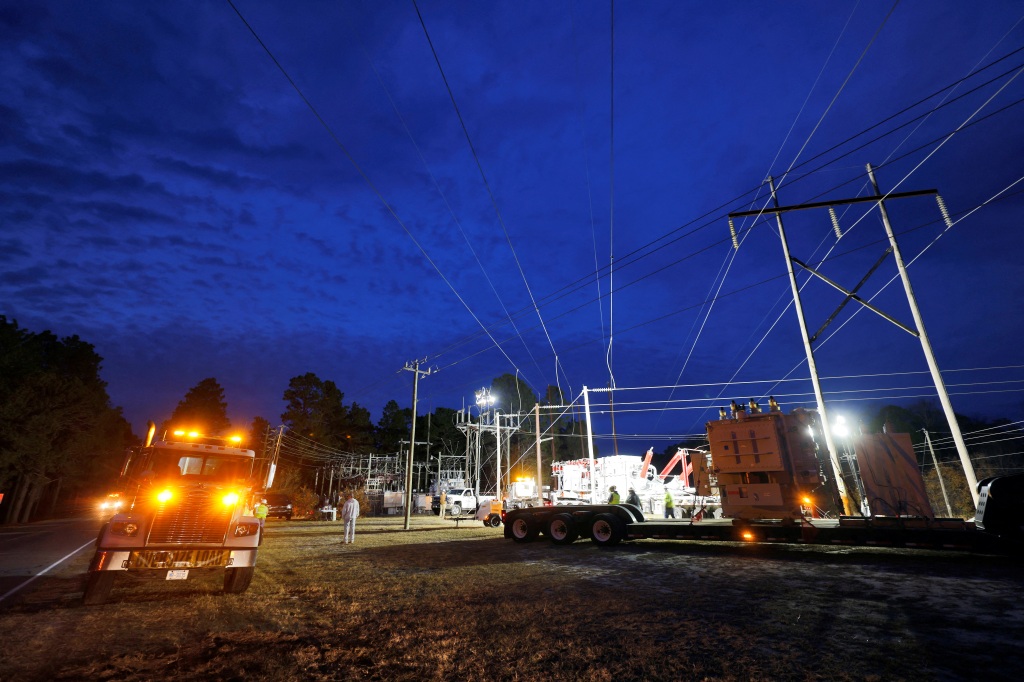 A picture of a Duke Energy personnel working to restore power.