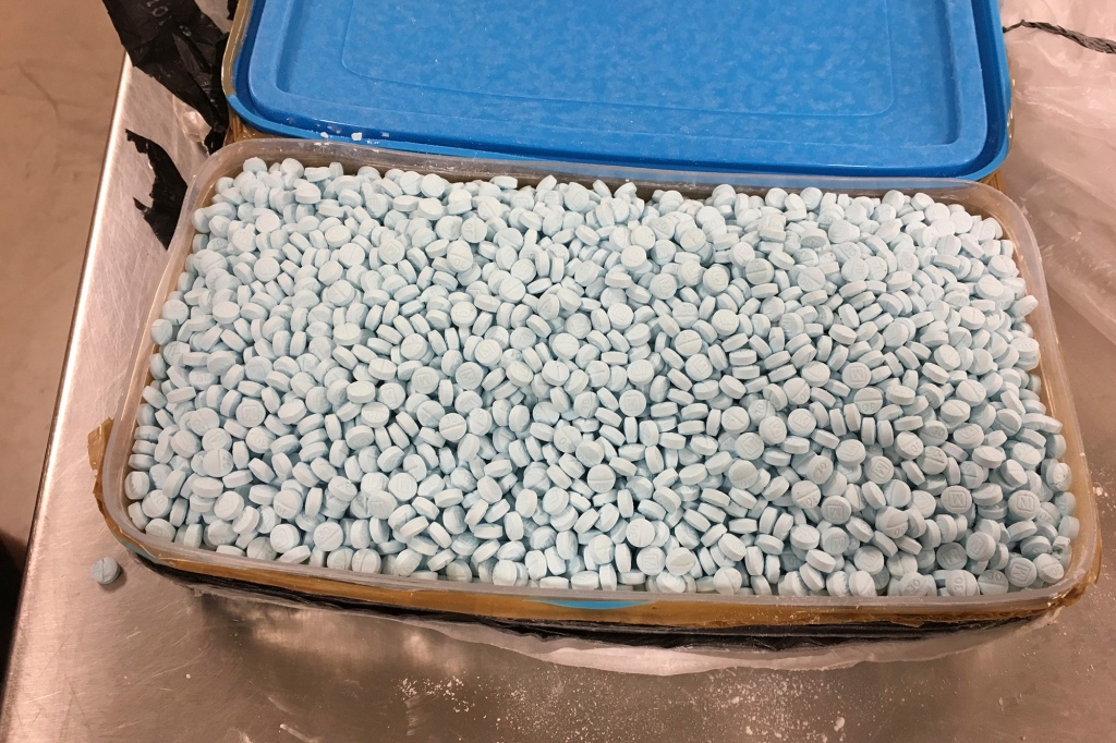 Containers holding thousands of fentanyl pills. 