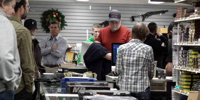 Customers wait in line at Northwest Armory Dec. 6, 2022, in Milwaukie, Oregon.