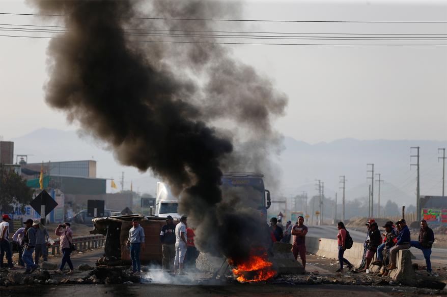 Supporters of ousted Peruvian President Pedro Castillo block the Pan-American North Highway to protest his detention in Viru, Peru,