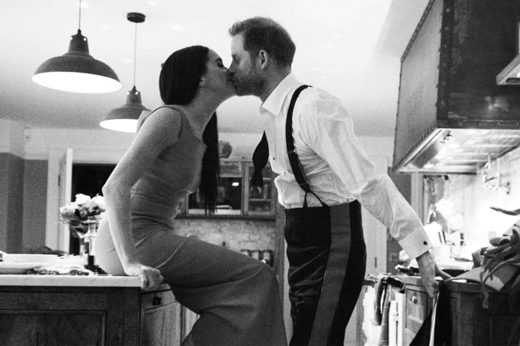 The couple kissing in kitchen.