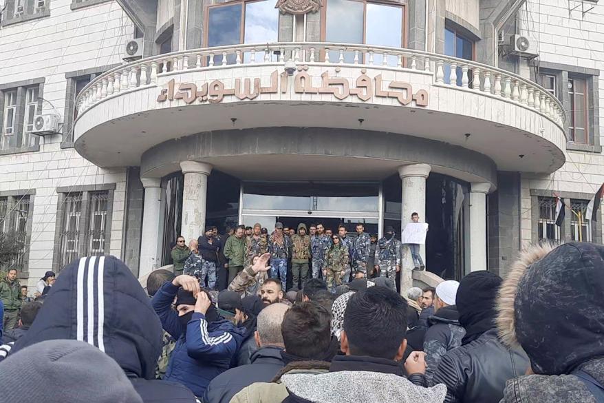 People gather as they take part in a protest in Sweida, Syria.