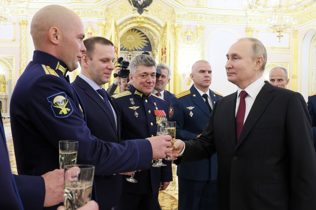  Putin (front) toasts with participants in a ceremony to present Gold Star medals to Heroes of Russia in St George's Hall of the Grand Kremlin Palace.