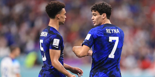 Giovanni Reyna of the U.S. interacts with teammate Antonee Robinson during a FIFA World Cup Qatar 2022 Group B match against England at Al Bayt Stadium Nov. 25, 2022, in Al Khor, Qatar.