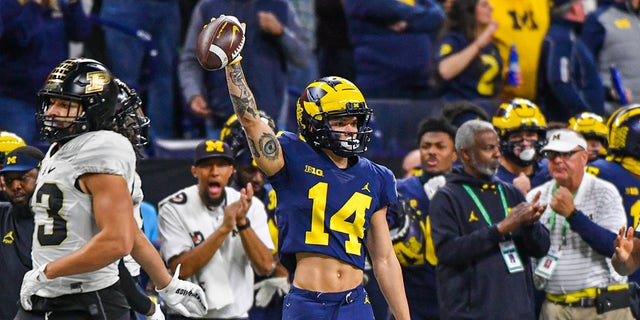 Roman Wilson #14 of the Michigan Wolverines reacts after catching a pass during the first half of the Big Ten football championship game against the Purdue Boilermakers at Lucas Oil Stadium on Dec. 03, 2022 in Indianapolis, Ind. 