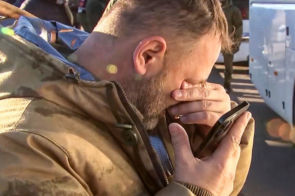A Russian serviceman reacting while he speaks with relatives on the phone, after a prisoner of war exchange with Ukraine.
