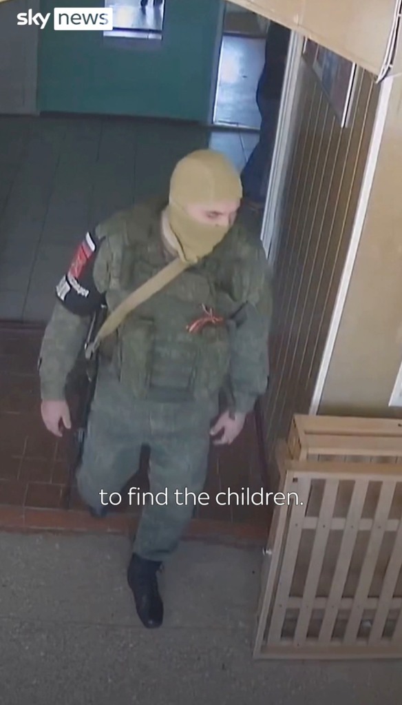 A Russian serviceman is seen walking through the Kherson orphanage in search of kids.