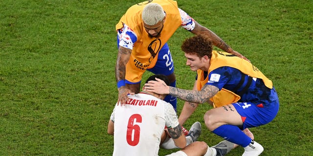 DeAndre Yedlin and Josh Sargent of the United States embrace Saeid Ezatolahi of Iran after a FIFA World Cup Qatar 2022 Group B match at Al Thumama Stadium Nov. 29, 2022, in Doha, Qatar.