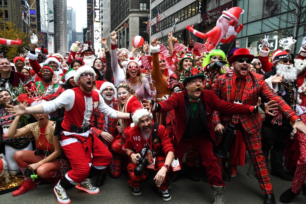 People dressed in Santa Claus costumes participate in SantaCon on December 11, 2021.