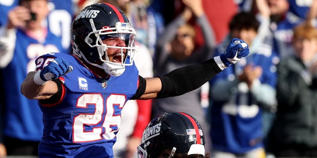 Saquon Barkley of the New York Giants celebrates after a touchdown in the second quarter against the Washington Commanders at MetLife Stadium on Dec. 4, 2022, in East Rutherford, New Jersey.