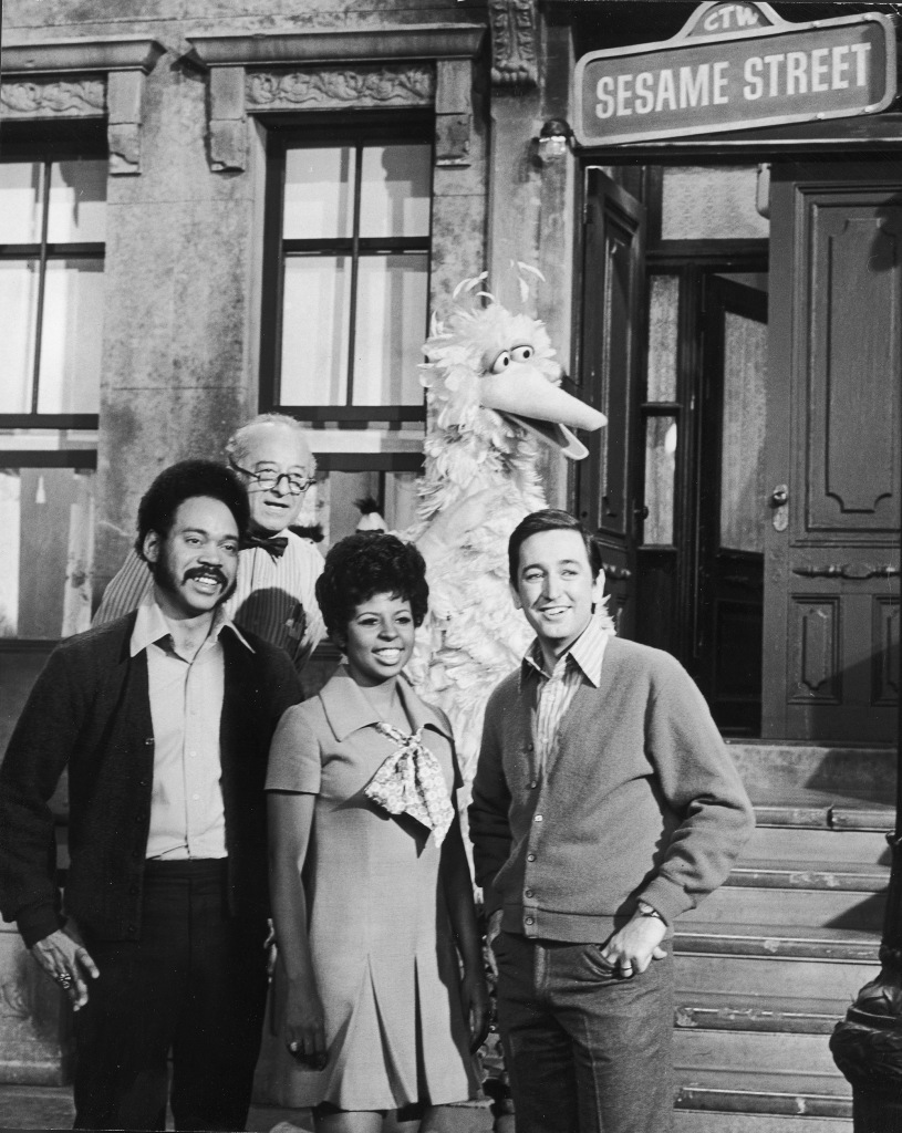 Hosts pictured on the Sesame Street set are Matt Robinson ,Will Lee,  Loretta Long and Bob McGrath..