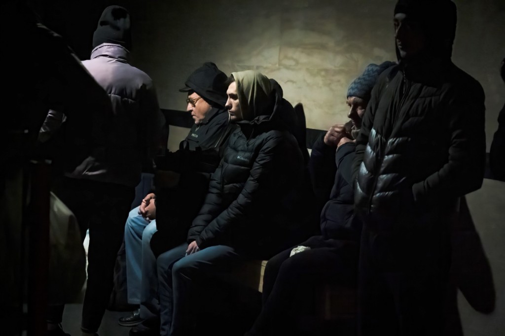 Civilians were seen sitting on a bench while seeking shelter at the train station in Dnipro on Dec. 17, 2022.
