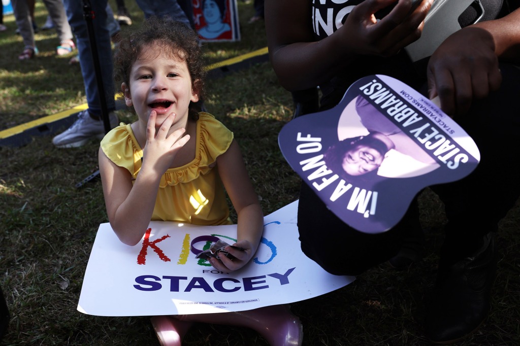 A young girl attends a rally for Stacey Abrams on Nov. 5 in Savannah, Ga.