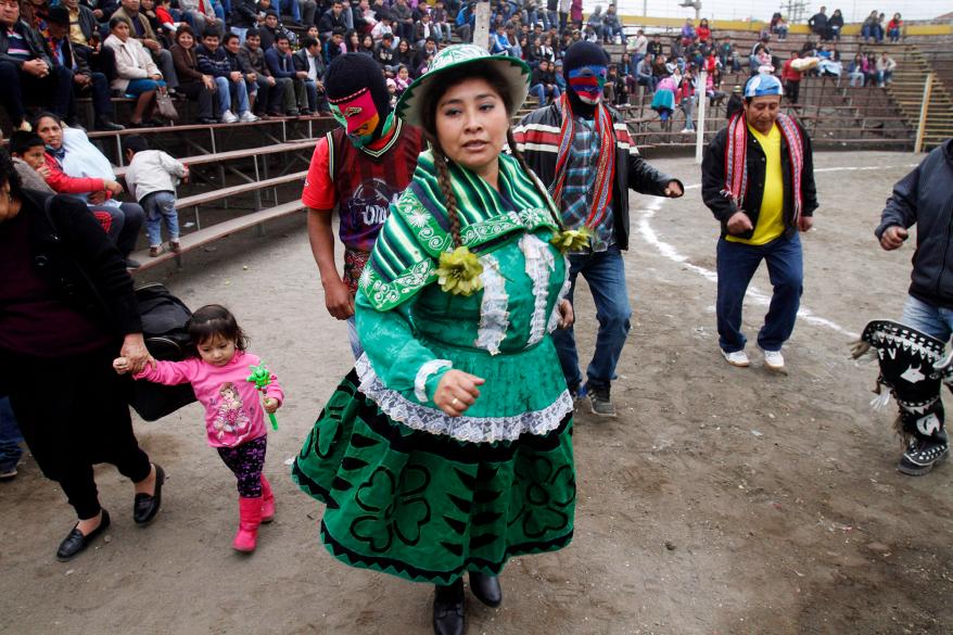 participants of the Takanakuy fighting ritual dance before the start of the event in Lima, Peru.