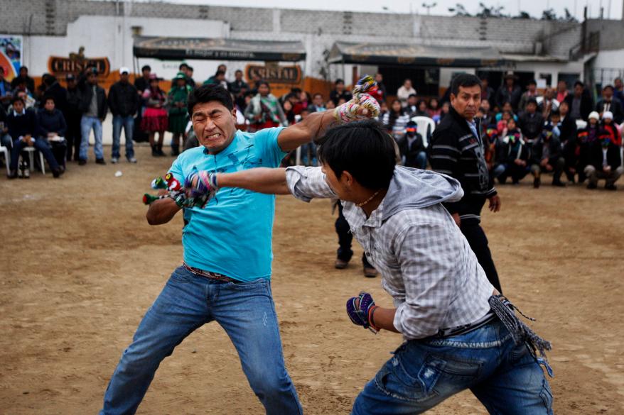 Andean men participate in a one-on-one fight during the "Takanakuy".