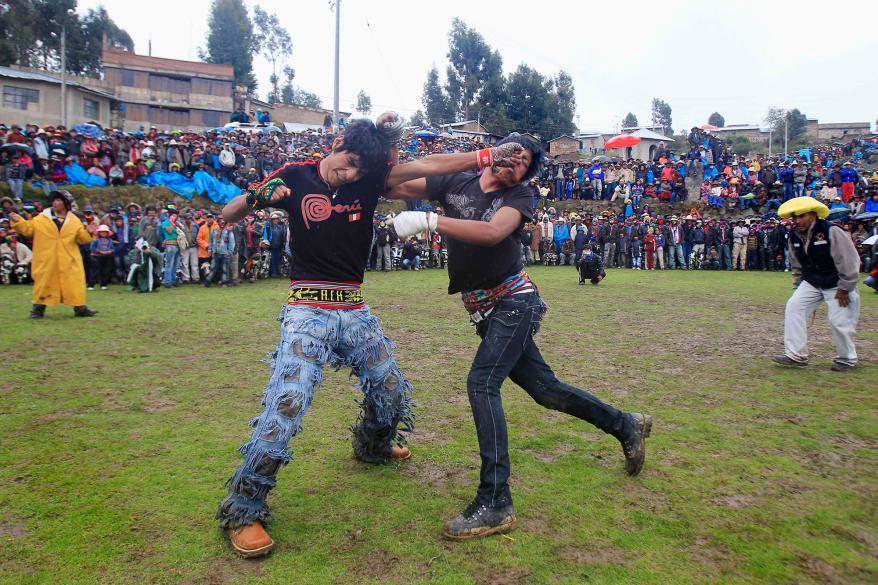 Andean men participate in a one-on-one fight during the "Takanakuy".