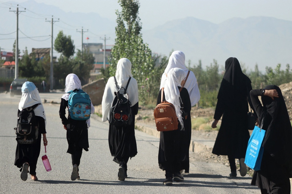 Girls walk to their school along a road in Gardez, Paktia