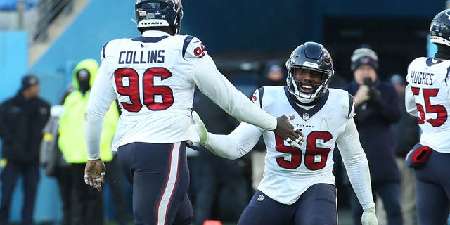 Houston Texans defensive tackle Thomas Booker IV (56) and Houston Texans defensive tackle Maliek Collins (96) celebrate after a fourth quarter interception during a game between the Tennessee Titans and the Houston Texans, December 24, 2022 at Nissan  Stadium in Nashville, Tennessee.