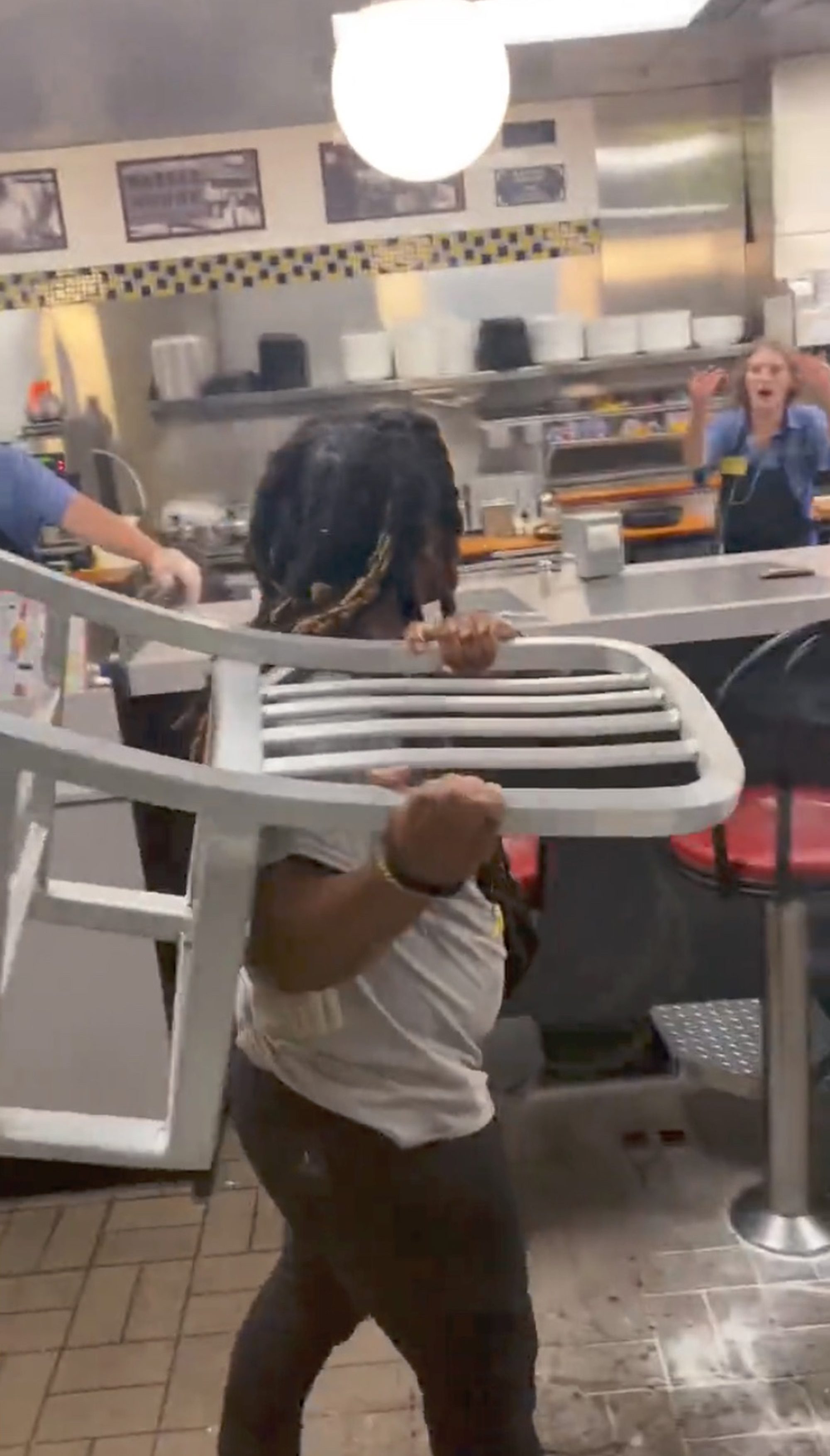 The employee took on the unruly patrons, even fending off a chair that was flung in her direction. 