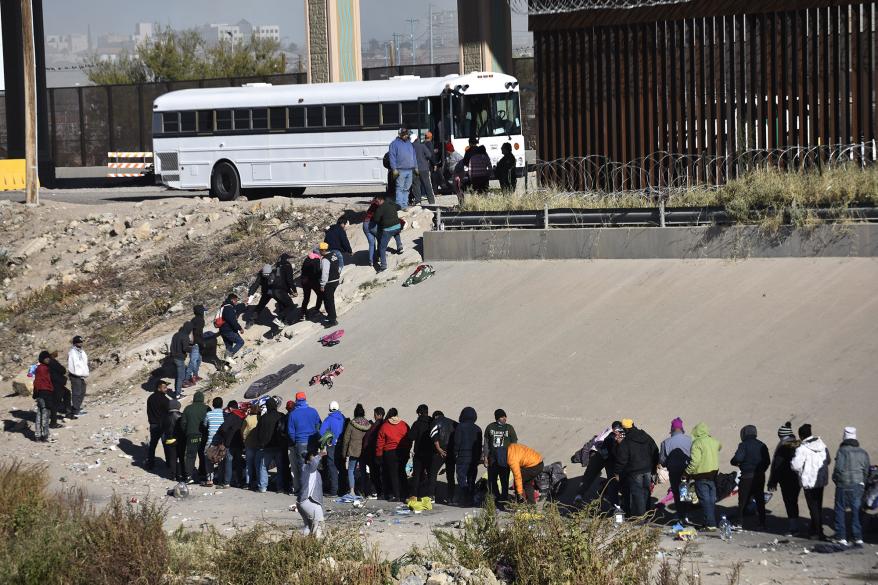 Hundreds of migrants who left shelters in Juarez yesterday and crossed the Rio Grande to request political asylum, wait to cross the border on the banks of the Rio Grande that divides Ciudad Juarez and El Paso Texas in Mexico on December 12, 2022.