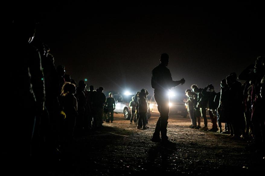 A Border Patrol officer gives instructions to migrants after they crossed the Rio Grande into the U.S. on May 05, 2022 in Roma, Texas.