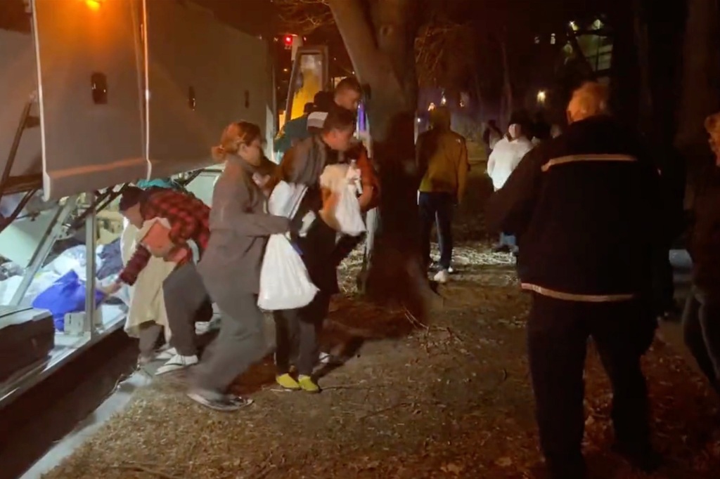 Migrants exit a bus near Vice President Kamala Harris' DC home on Christmas Eve. 