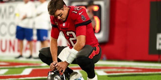 Tom Brady #12 of the Tampa Bay Buccaneers kneels in the end zone prior to an NFL football game against the New Orleans Saints at Raymond James Stadium on December 5, 2022 in Tampa, Florida.