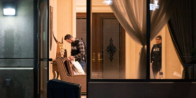 Police stand in the lobby of a condominium building following a shooting in Vaughan, Ontario, Sunday.