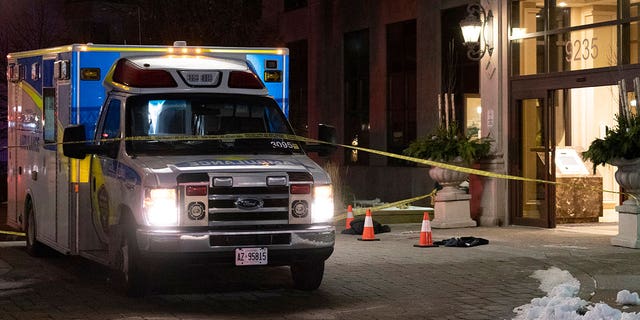 An ambulance is parked outside the lobby of a condominium building following a fatal shooting in Vaughn, Ontario.