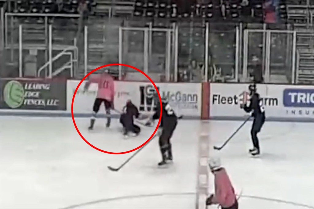 Trans hockey player knocked to the ice