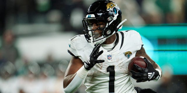 Travis Etienne Jr. #1 of the Jacksonville Jaguars carries the ball against the New York Jets during the first half at MetLife Stadium on December 22, 2022, in East Rutherford, New Jersey.