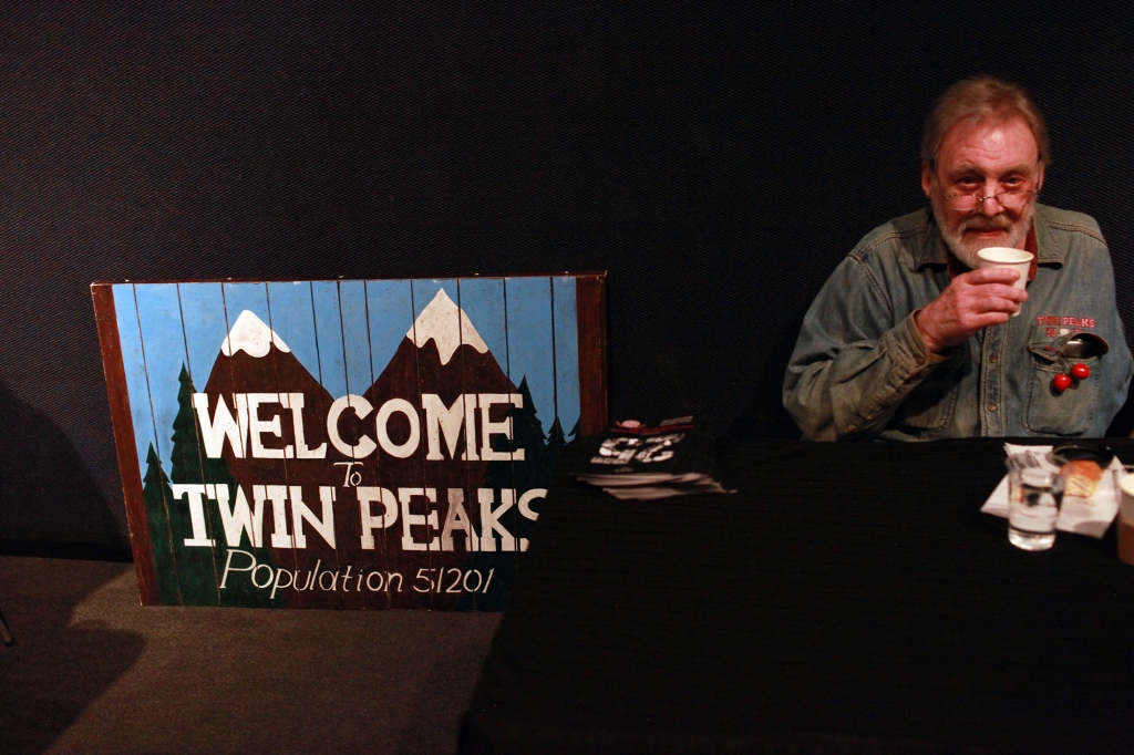 Strobel drinks a cup of coffee while signing autographs for fans during the sixth annual Twin Peaks UK Festival at Genesis Cinema on October 3, 2015 in London, England.