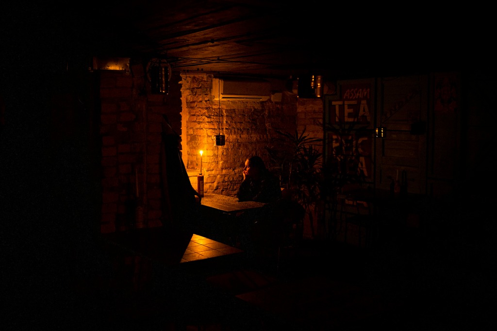 A restaurant patron sitting in the dark.