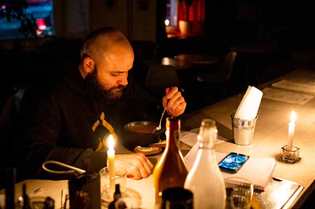 A man eating by candlelight