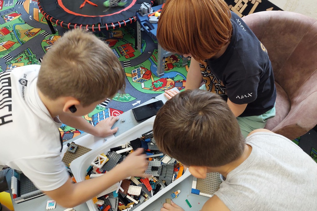 Ukrainian refugees playing with Legos in Prague.