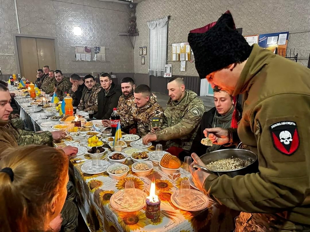 Ukrainian service members are pictured having Christmas dinner.